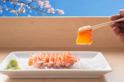 Close-up of hand holding food on table