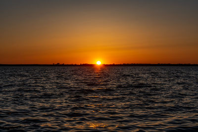 Scenic view of sea against romantic sky at sunset