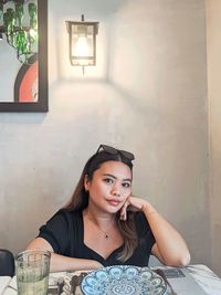 Young woman sitting at home