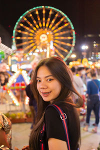 Portrait of a smiling young woman in amusement park