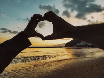 Low section of person on sand at beach