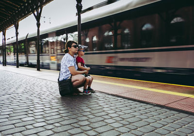 Woman sitting on train at railroad station