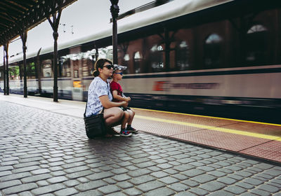 Woman sitting on train at railroad station