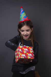 Girl standing against multi colored background