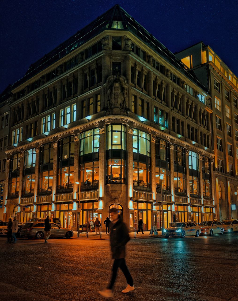 FULL LENGTH OF ILLUMINATED STANDING AT NIGHT