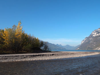 Scenic view of mountains against clear blue sky