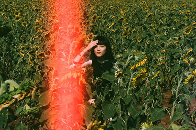 Portrait of young woman standing on field