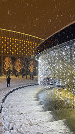 View of illuminated street during winter at night