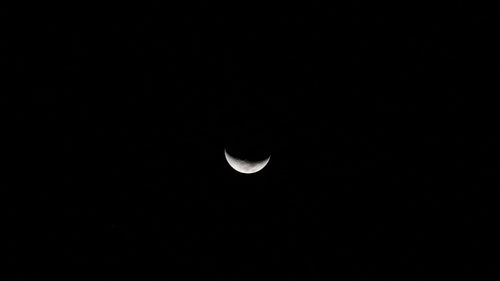 Low angle view of moon against clear sky at night