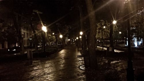 Wet illuminated street light in city during rainy season