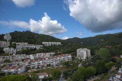 High angle view of buildings in town against sky