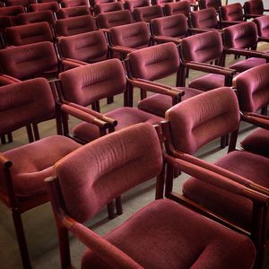 Full frame shot of empty chairs arranged in room