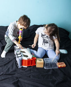 Siblings sitting on floor