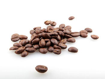 High angle view of coffee beans against white background