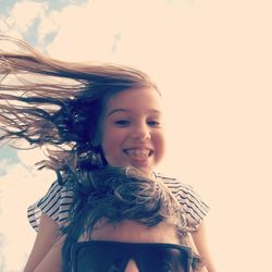 Portrait of smiling girl with father against sky