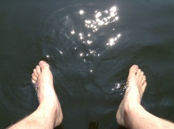 Low section of person standing on tiled floor