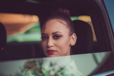 Close-up of young woman sitting in car