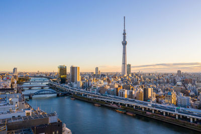 View of bridge and buildings against sky