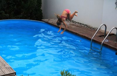 Full length of girl diving in swimming pool