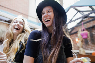 Happy young friends enjoying drinks at a bar