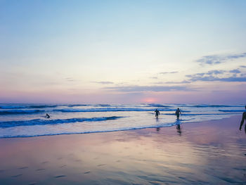 Scenic view of beach against sky during sunset