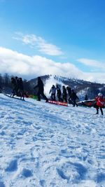 People skiing on snow covered mountain