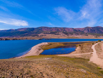 Scenic view of landscape and mountains against sky