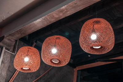 Low angle view of illuminated pendant light hanging from ceiling