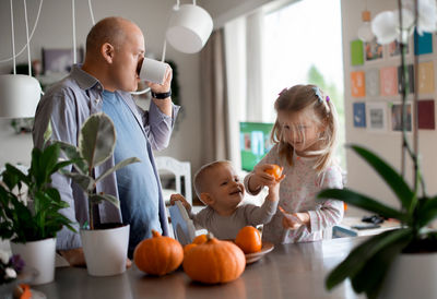 Grandfather with children at home