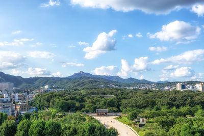 Panoramic view of trees and buildings against sky