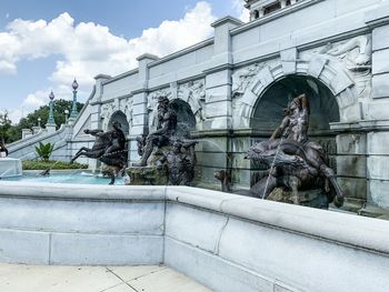 Low angle view of statue against historic building