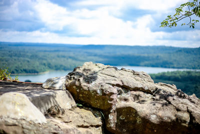Scenic view of rocks on beach against sky