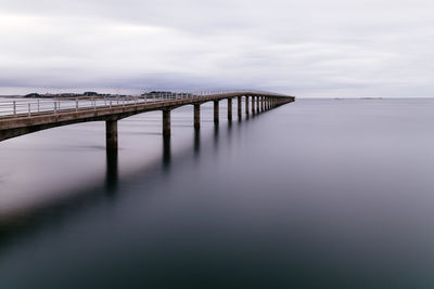Pier over sea against sky