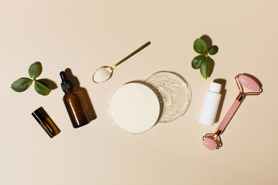 Anti-aging cosmetics. collagen powder and hyaluronic acid in petri dishes, cosmetic bottles 