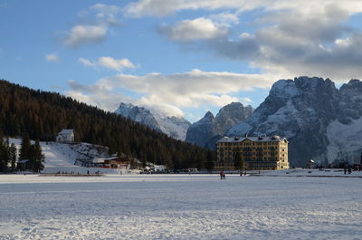 Scenic view of snowcapped mountains against cloudy sky