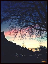 Low angle view of buildings against sky at sunset