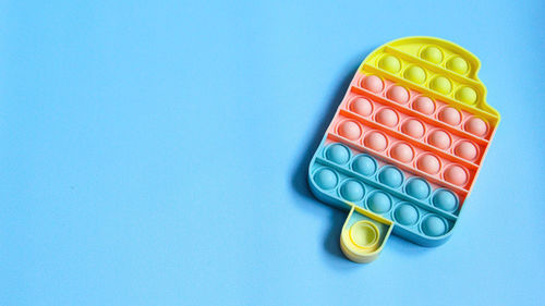 High angle view of candies against blue background