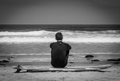 Rear view of man looking at sea shore