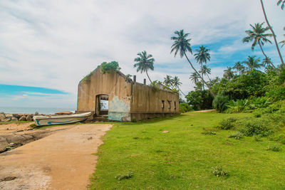 Built structure on field against sky