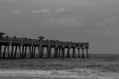 Pier over sea against sky