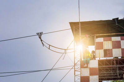 Low angle view of cables against clear sky