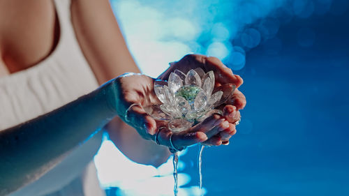 Low angle view of woman holding seashell