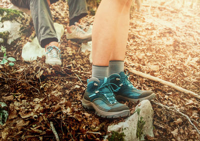 Low section of people standing on land in forest