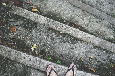 Low section of person standing on tiled floor