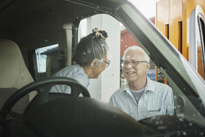 Senior couple in van at gas station