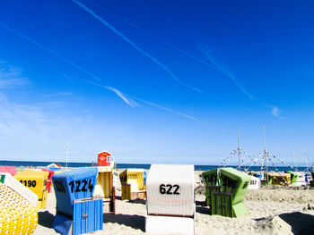 Text on beach against blue sky