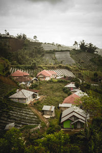 High angle view of houses and buildings against sky