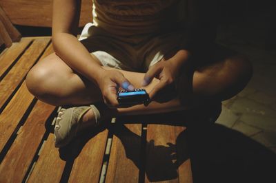 Midsection of man using mobile phone