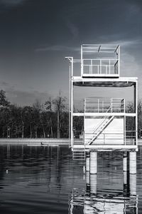 Reflection of building on lake against sky