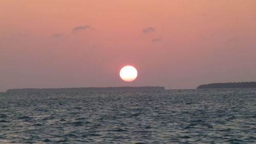 Scenic view of sea against sky at sunset